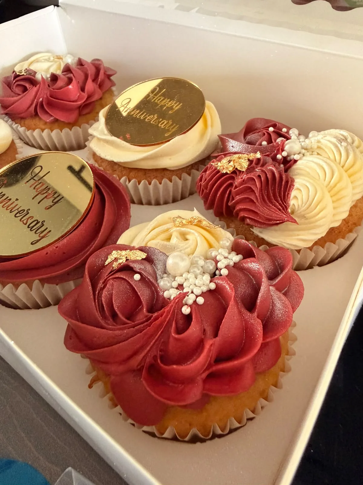 Red and cream celebration cupcakes with gold decorations